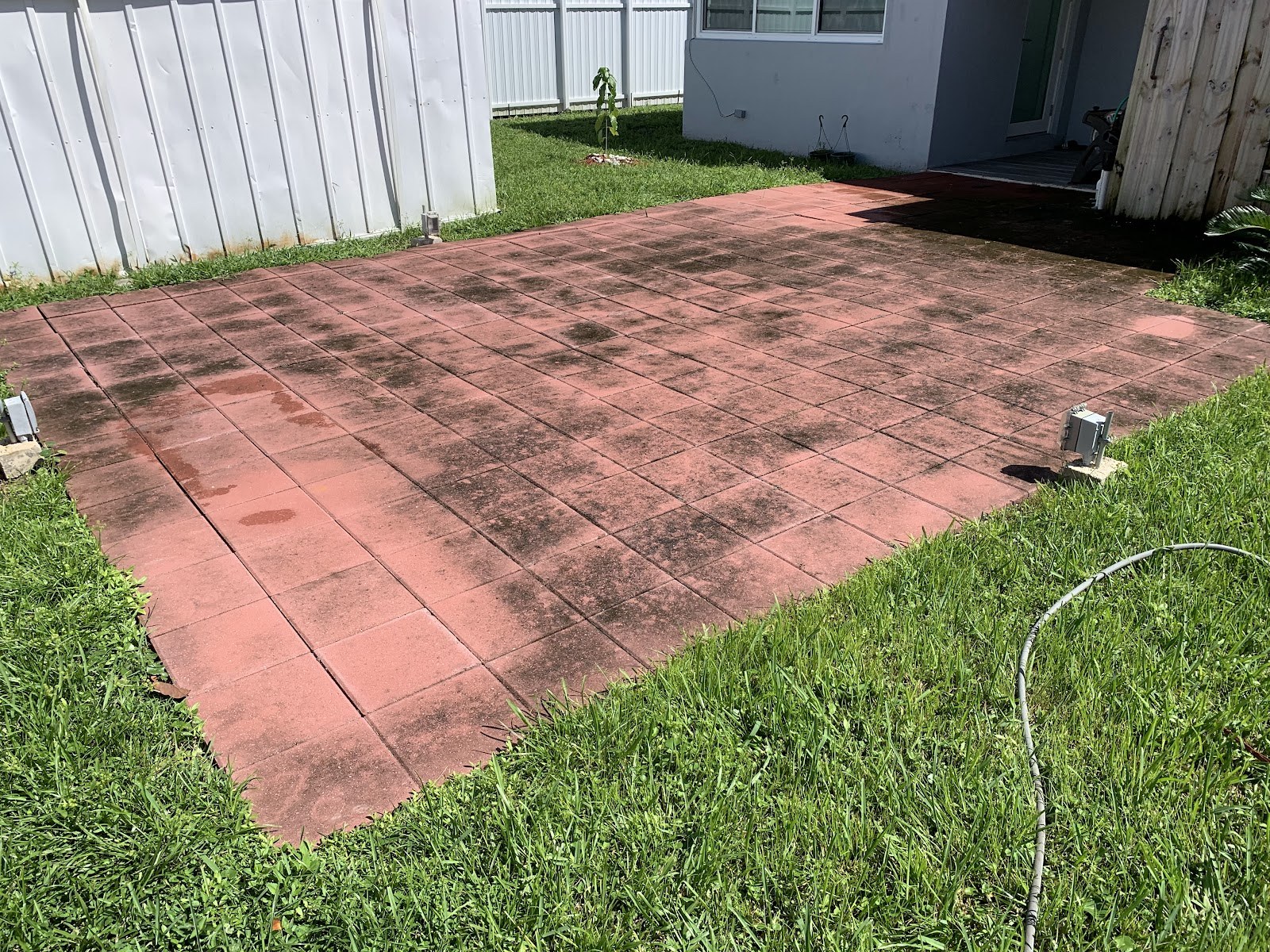Red patio slab, weathered before cleaning